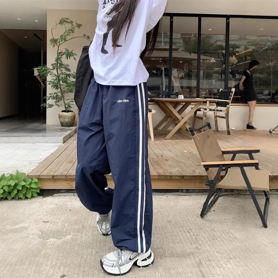 Pantaloni sportivi da donna in stile americano ad asciugatura rapida, estivi, larghi, a righe, sottili, traspiranti, casual, a gamba larga, lunghi.