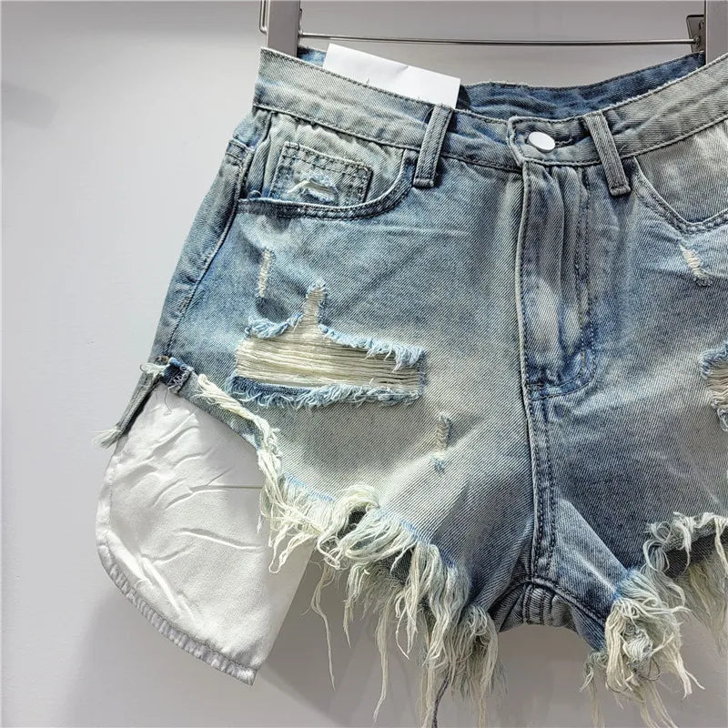 Nuova collezione estate 2026: pantaloncini in denim rosa con fori, vita alta, modello snellente, linea ad A, orlo sfrangiato.
