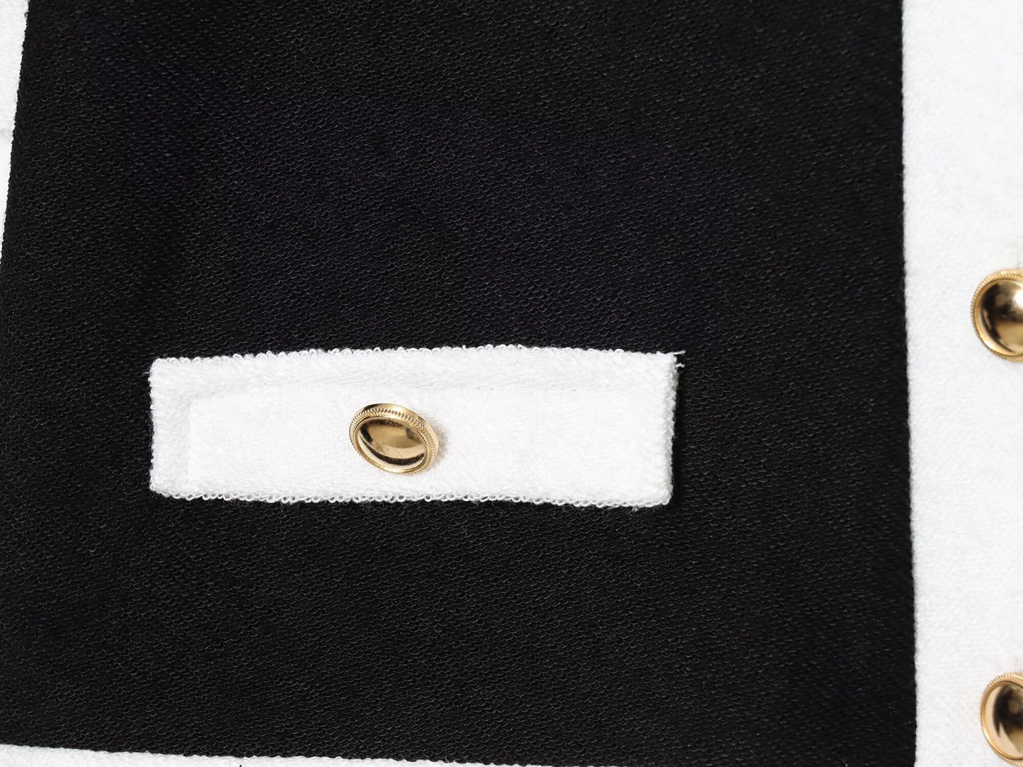 Completo composto da giacca a maniche corte con scollo rotondo in pelle perlata a contrasto, elastico in vita e pantaloni a vita alta