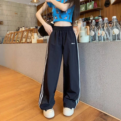 Pantaloni sportivi da donna in stile americano ad asciugatura rapida, estivi, larghi, a righe, sottili, traspiranti, casual, a gamba larga, lunghi.