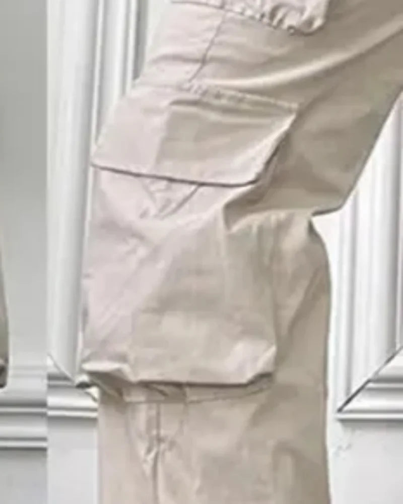 Pantaloni da lavoro da donna a tinta unita con tasche, vita alta e elastico in vita.