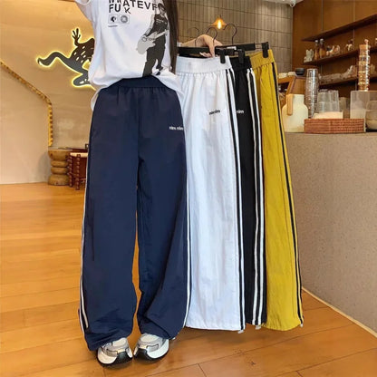 Pantaloni sportivi da donna in stile americano ad asciugatura rapida, estivi, larghi, a righe, sottili, traspiranti, casual, a gamba larga, lunghi.